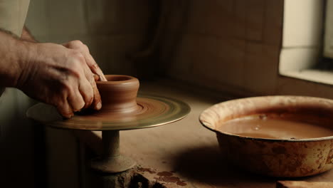 Man-working-with-clay-in-workshop