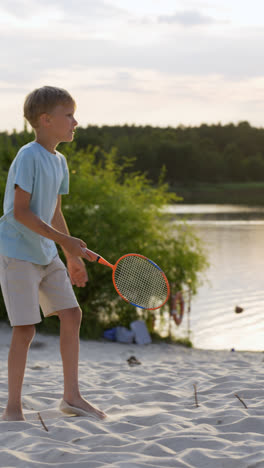 Boy-playing-badminton-at-the-beach