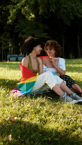 Couple-with-pride-flag-in-the-park