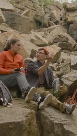 Climbers-sitting-on-a-rock