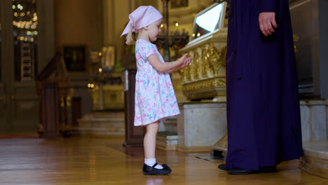 Kid-approaching-to-the-priest