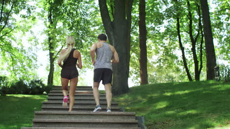 Sport-couple-running-upstairs-at-workout-outdoor