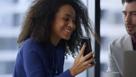 Excited-african-american-business-woman-showing-mobile-phone