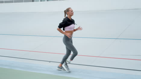 Sportswoman-jogging-on-racetrack
