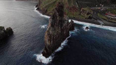 Aerial-drone-view-of-a-cliff-by-the-ocean-with-waves-crashing-at-Madeira