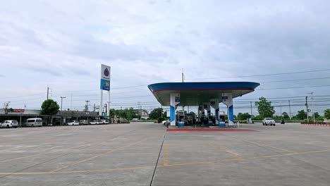 A-pick-up-truck-driving-in-a-gas-station-towards-the-convenience-store-in-Pattay,-Chonburi-province,-in-Thailand