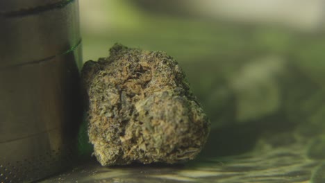 a-panning-shot-to-a-close-up-bud-of-marijuana-and-a-weed-grinder