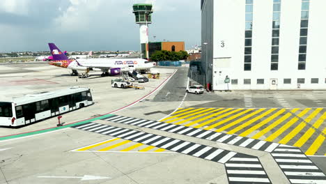 Airport-scene-with-bus-crossing-and-airplanes