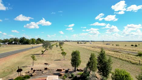 Drone-footage-of-the-historic-Welcome-to-Longreach-sign-rising-to-show-the-town-in-the-distance