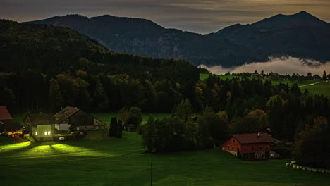 Village-countryside-valley-with-rolling-mist-at-nightfall,-timelapse