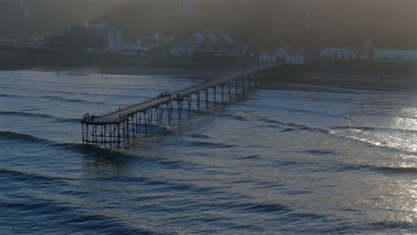 Establishing-Drone-Shot-of-Saltburn-by-the-Sea-Pier-at-High-Tide-UK