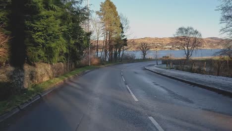 POV-shot-driving-through-villages-in-the-Scottish-Highlands-revealing