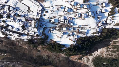Aerial-view-of-snowy-Bernese-Highland-Switzerland-village-near-mountain-edge