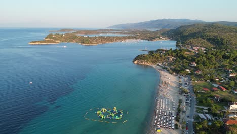 Trani-Ammouda-Beach-and-Water-Playground-in-Halkidiki,-Greece---Aerial-4k