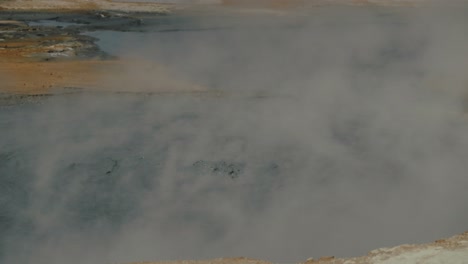 Bubbling-and-steaming-mud-pools-in-Iceland-geothermal-landscape,-slow-motion