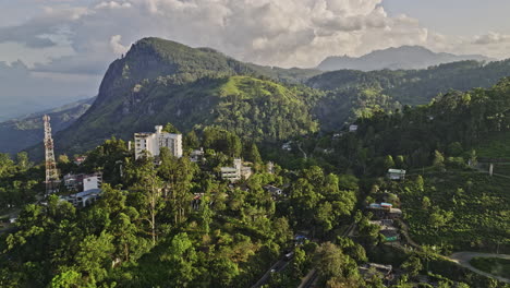 Ella-Sri-Lanka-Aerial-v1-panoramic-panning-shot-capturing-railway-station,-town-center,-hillside-resort-hotels-and-beautiful-mountain-landscape-of-rock-point---Shot-with-Mavic-3-Cine---April-2023