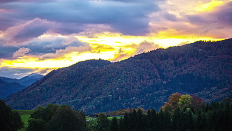 Timelapse-of-clouds-rolling-over-wooded-mountains-and-valley-at-sunset