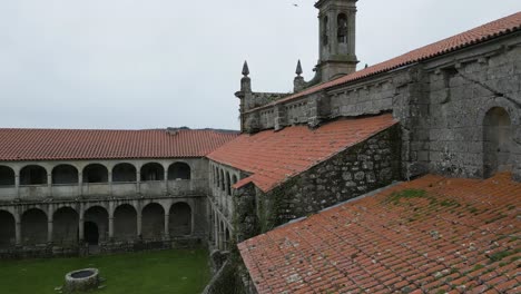 Closeup-aerial-tilt-up-to-carved-stone-tower-of-Santa-Maria-de-Xunqueira-monastery