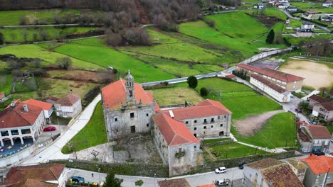Tilt-down-to-monastery-in-lush-green-village-of-spain