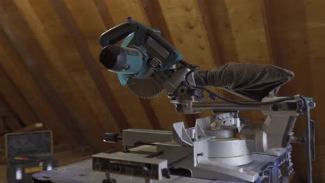 Mitre-saw-with-protective-cover-set-in-a-woodworking-shop,-detailed-shot-capturing-the-essence-of-carpentry