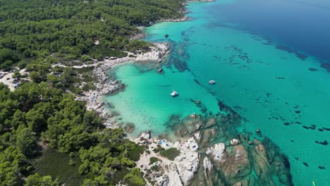 Beach-Kavourotrypes-and-Clear-Blue-Sea-Coastline-in-Halkidiki,-Greece---Aerial-4k