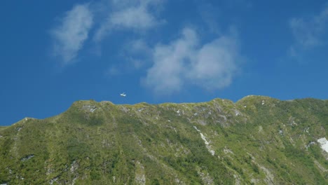 Aerial-wonder:-Plane-flying-below-mountain-at-Milford-Sound-in-captivating-stock-footage