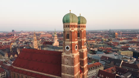 Aerial-orbiting-shot-of-beautiful-historic-Cathedral-named-Frauenkirche-in-Munich-at-golden-sunrise