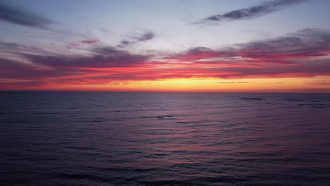 Pastel-horizon:-Pink-sky-over-ocean-after-sundown-in-enchanting-stock-footage
