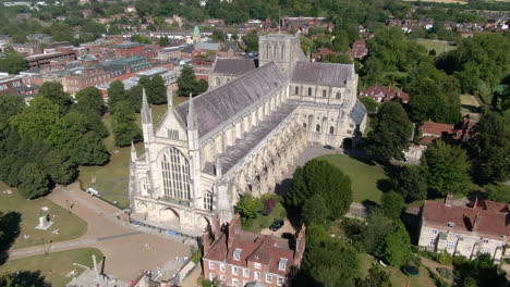 Overview-drone-shot-of-Winchester-Cathedral-and-grounds,-filmed-in-Summer-in-Hampshire,-UK