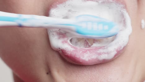 Man-brushing-teeth-with-a-manual-toothbrush