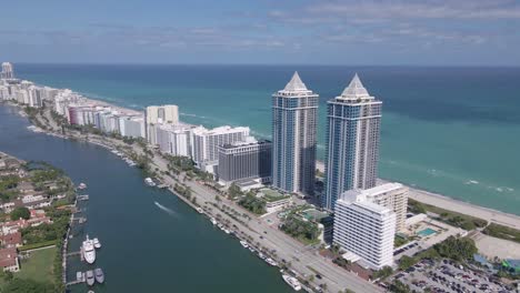 A-mesmerizing-aerial-view-of-contemporary-hotel-structures-lining-the-ocean,-presenting-an-impressive-spectacle-of-architecture-and-water-vistas
