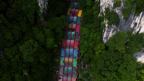 Tourists-Climbing-On-Colorful-Steep-Steps-To-Batu-Caves-In-Gombak,-Selangor,-Malaysia