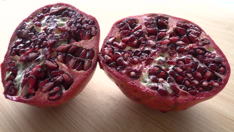 Rotating-pomegranate-fruit-and-seeds,-top-view,-4K
