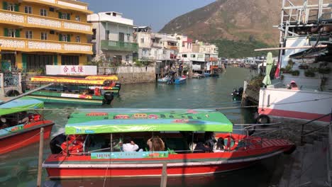 Tourists-wait-in-a-boat-for-a-tour-around-the-Tai-O-waterway-on-Lantau-Island,-Hong-Kong