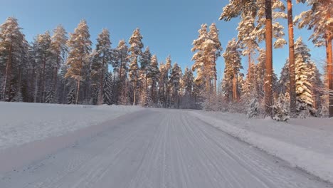 Skilled-driver-POV-navigates-snow-and-ice-winter-forests-roads-Finland
