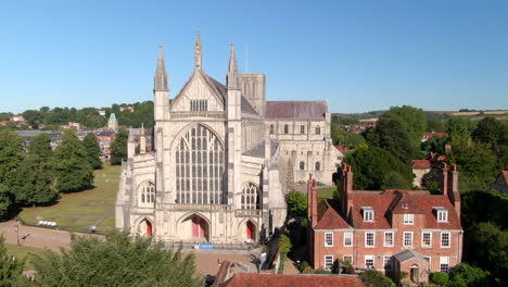 Drone-tracking-shot-of-Winchester-Cathedral,-captured-in-Summer-in-Hampshire,-UK