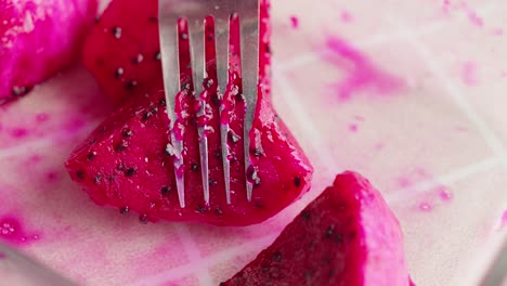 Pricking-delicious-red-dragon-fruit-with-fork