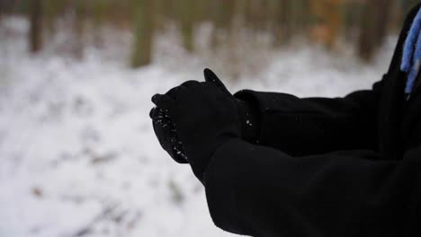 Woman-Gets-Handful-Of-Snow-And-Makes-A-Snowball,-Camera-Close-Up
