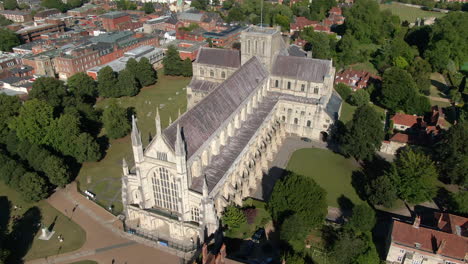 Orbiting-drone-shot-over-Winchester-Cathedral,-filmed-in-Summer-in-Hampshire,-UK