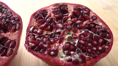 Rotating-pomegranate-fruit-and-seeds,-top-view,-4K