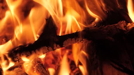Captivating-Super-Slow-Motion:-A-Mesmerizing-Close-Up-as-Wood-Embraces-the-Fiery-Embrace,-Slowly-Dissolving-in-the-Warm-Embers-of-a-Cozy-Fireplac