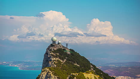 Moving-clouds-time-lapse,-meteorological-unit-green-landscape-Gibraltar,-overlooking-blue-sea