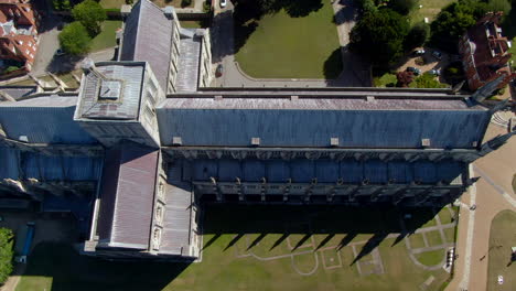 4K-Bird's-eye-view-shot-of-Winchester-Cathedral,-during-Summer-in-Hampshire,-UK