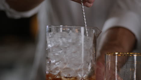 Bartender-Stirs-an-Old-Fashioned-in-Ice-in-a-Large-Mixing-Glass