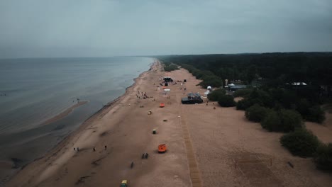 Aerial-establishing-shot-of-Baltic-Beach,-Vecāķi-at-sunset