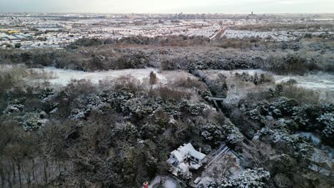 UK-snowy-blast-brings-winter-wonderland---view-of-Wirral-peninsula-from-Bidston-Hill,-Wirral---aerial-drone-360-degree-rotate-around-Windmill