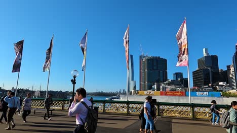 Slow-motion-clip-of-people-walking-across-Pyrmont-bridge,-Darling-harbour-Sydney