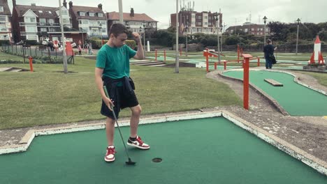 Young-boy-playing-crazy-golf-at-the-coastal-town-of-Skegness