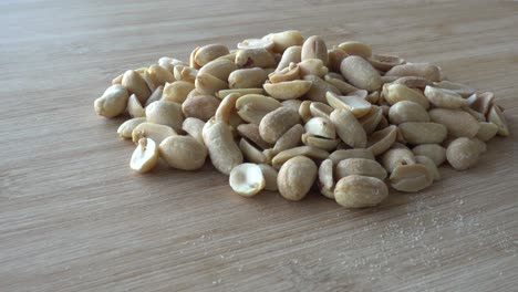 Hand-Peacking-Salted-peanuts-close-up