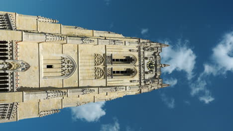Vertical-low-angle-shot-of-Basilica-of-Our-Lady-tower-on-sunny-day,-Tongeren,-Belgium